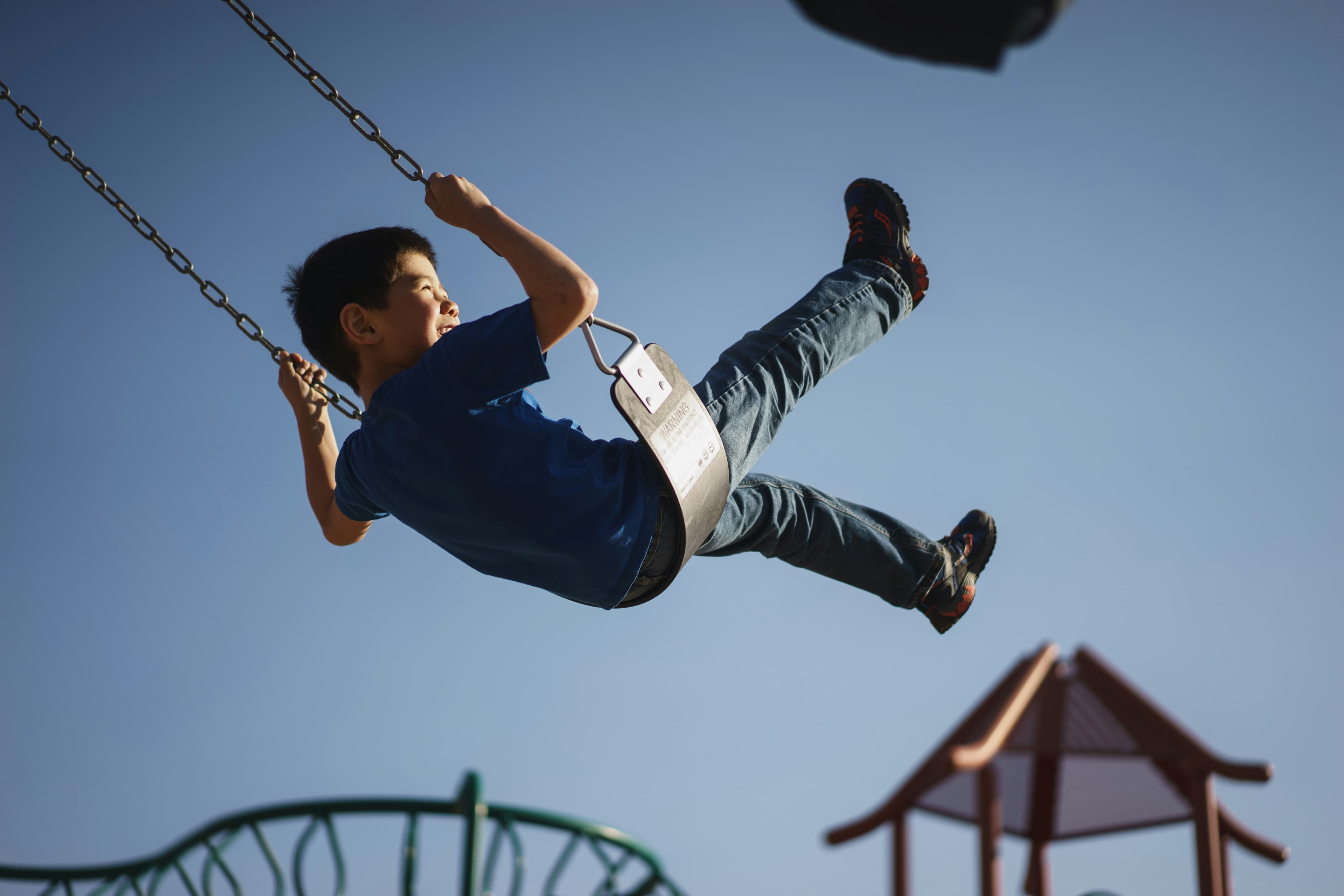 Children playing on a swing at Children's Health Partners
